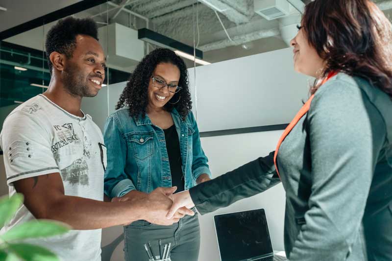 Couple shaking hands with representative